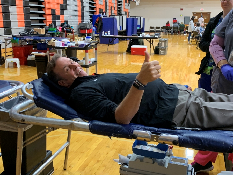 man with a thumbs up giving blood